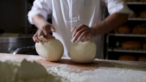 Artisan Baker Hand-Kneading Dough in Rustic Bakery Stock Footage 284028257