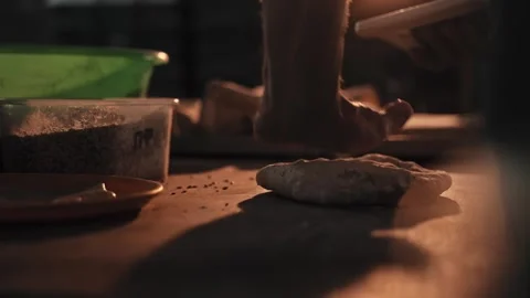 Artisan baker hands kneading dough on rustic wooden table for bread rolls, Stock Footage 344094000