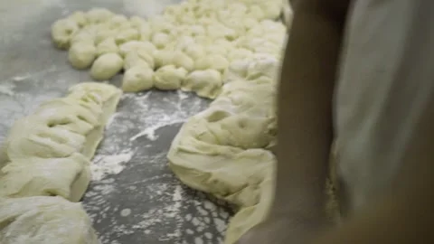 An artisan baker puts flour on dough to make chapatis cakes, in Bahrain Stock Footage 245257295