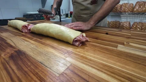 Artisan Baker Rolling Traditional Ham Bread Dough in Professional Kitchen Stock Footage 337438745