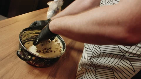 Artisan baking scene with textured dough and striped apron Vidéo 330536835