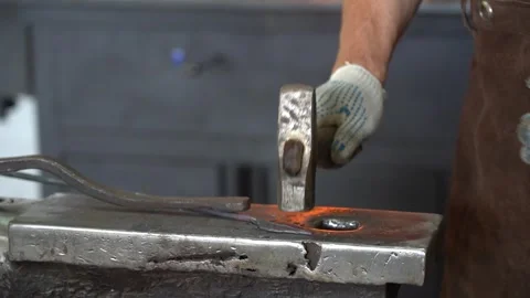 An Artisan Blacksmith at Work: The Craftsmanship of Shaping Metal with Hammer Stock Footage 341316894