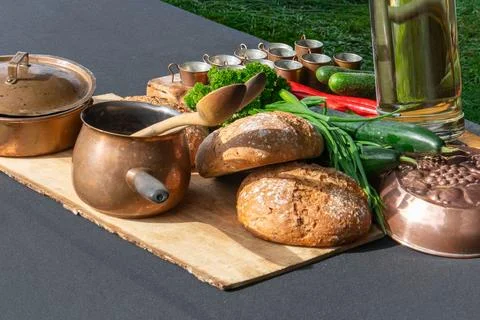 Artisan Bread And Copper Cookware On Wooden Board Stock Photos