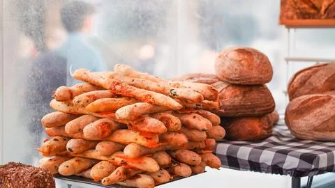 Artisan bread and crispy breadsticks on display at a London bakery shop. Stock Photos