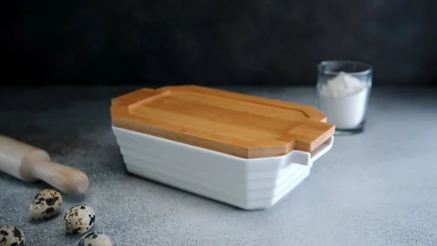 Artisan Bread Baking in a Ceramic Loaf Pan on a Rustic Kitchen Counter Stock Footage 273700511