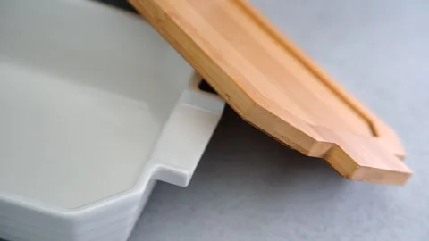 Artisan Bread Baking in a Ceramic Loaf Pan on a Rustic Kitchen Counter Stock Footage 273700590