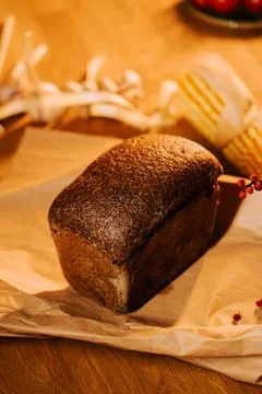 Artisan bread displayed on rustic table with decorative elements Stock Photos