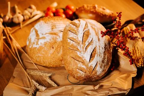 Artisan bread displayed on rustic table with decorative elements 写真素材