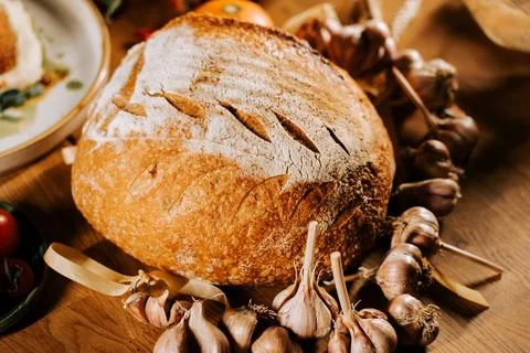 Artisan bread displayed on rustic table with decorative elements 스톡 사진