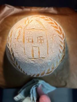 Artisan Bread Featuring Unique House Design and Intricate Flour Patterns for Stock Photos