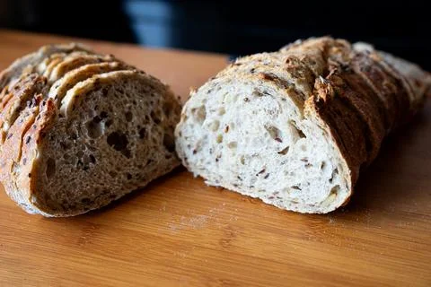 Artisan bread halves with golden crust Stock Photos