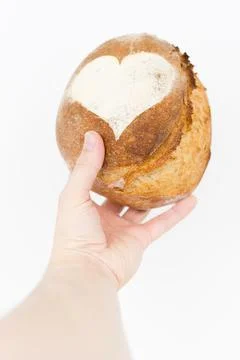 Artisan bread in hand on white background Stock-Fotos