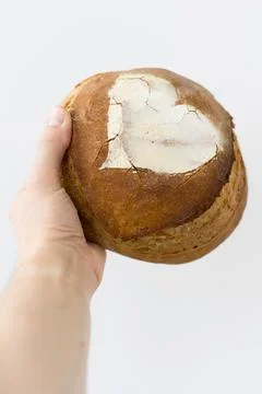 Artisan bread in hand on white background Stock Photos