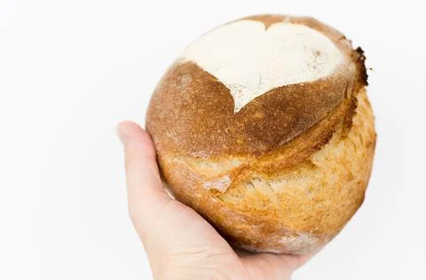 Artisan bread in hand on white background Stock Photos
