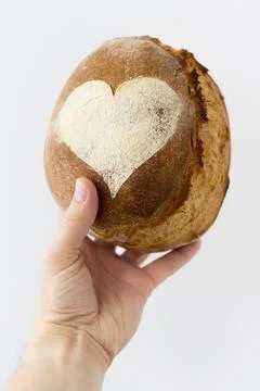 Artisan bread in hand on white background Stock Photos