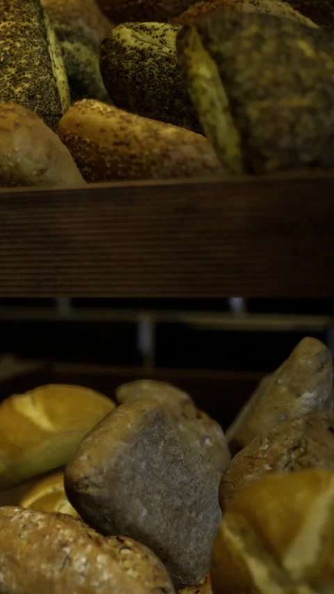 Artisan breads showcase rustic charm in a cozy bakery setting Stock Footage 331690207