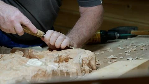 Artisan carves pattern, Master woodworker skillfully creates elegant motifs Stock Photos