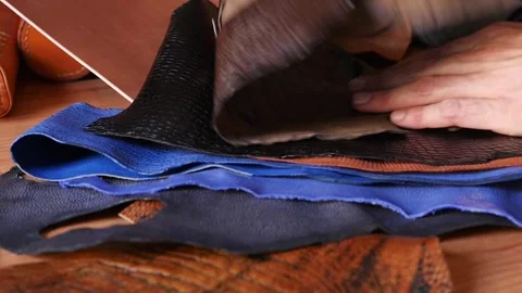 Artisan checking premium crocodile texture leather sheets for watch straps Stock Footage 335458872