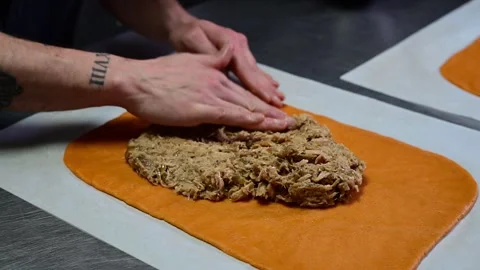 Artisan chef kneading orange dough for gallego empanada Stock-Footage 330428848