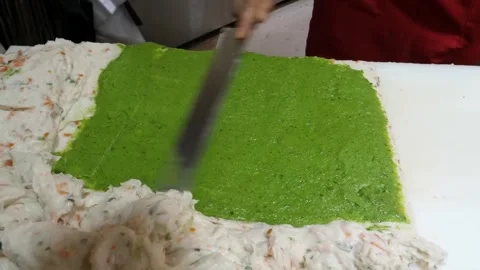 Artisan Chef Spreading Green Seafood Paste for Korean Fish Cake (Eomuk) Preparat Stock Footage 337372976