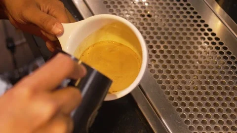 Artisan Coffee Preparation with Latte Art Swirl Pattern in White Cup at Stock Footage 336418155
