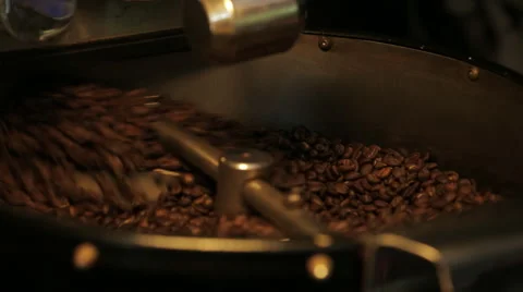 Artisan Coffee Roaster close up of beens being roasted shot Video stock 64998057