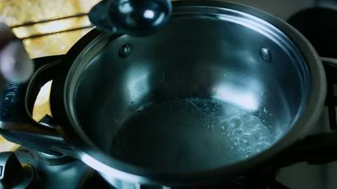 Artisan cooking study of clear syrup beginning to simmer Stock Photos