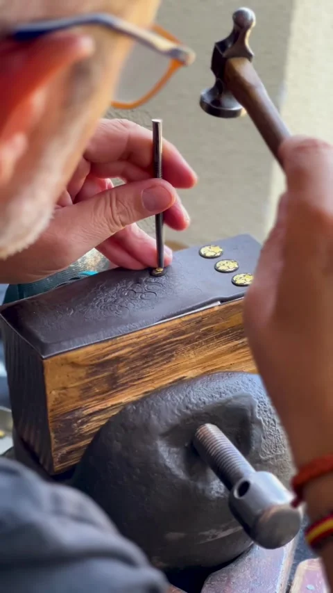 Artisan Craftsman Using Hammer And Punch On Metal Jewelry In Workshop 動画素材 347138032