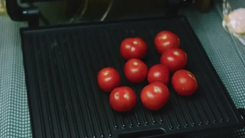 Artisan culinary view of tomatoes grouped on a hot grill pan Stock Footage 342152645
