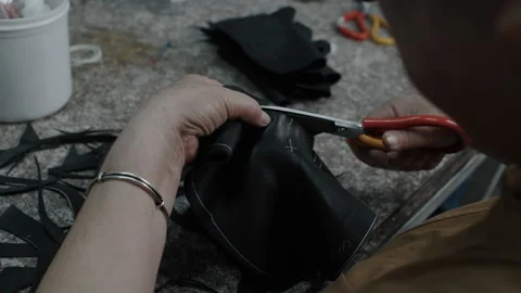 Artisan Cutting Leather by Hand for Shoe Manufacturing in Workshop Setting Stock Footage 341667813