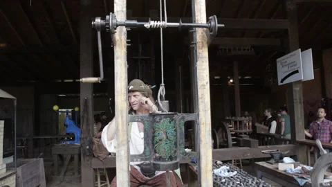 Artisan Demonstrating Historical Drop Hammer Coin Press Stock Footage 345275886