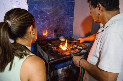 Artisan demonstrating silver melting to apprentice Stock Photos
