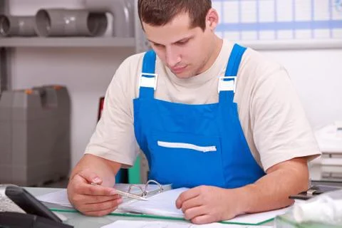 Artisan doing paperwork Stock Photos