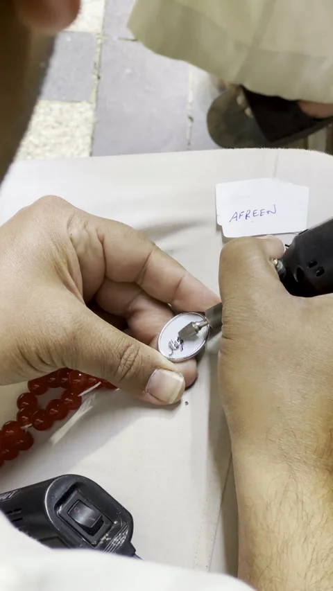 Artisan Engraving Afreen on Custom Red Prayer Beads Stock Footage 332298260