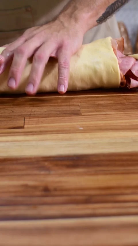 Artisan Ham Bread Rolling Process in Rustic Kitchen Close-Up Stock Footage 332421100