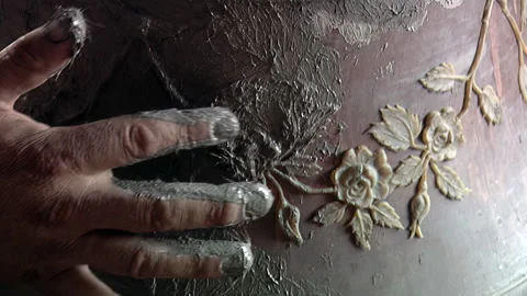 Artisan Hand Applying Clay Mixture over Decorative Rose Reliefs on Bell Mold 4K Video stock 340171253