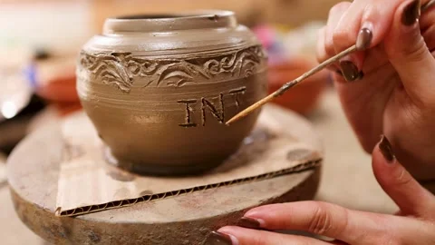 Artisan Hand Carving Intricate Patterns on Clay Pottery Vessel Stock Footage 339753731