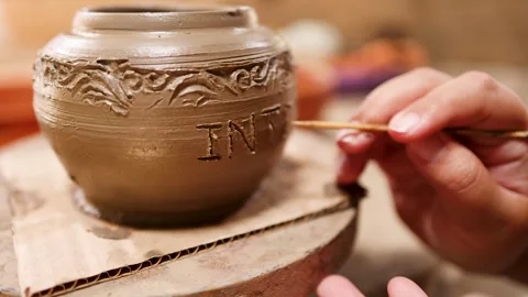 Artisan Hand Carving Intricate Patterns on Traditional Clay Pottery Vessel Stock Footage 340247281