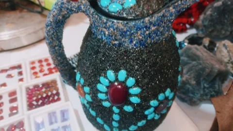 Artisan Handcrafted Black Pitcher Adorned With Turquoise And Red Gemstones Stock Footage 342153402