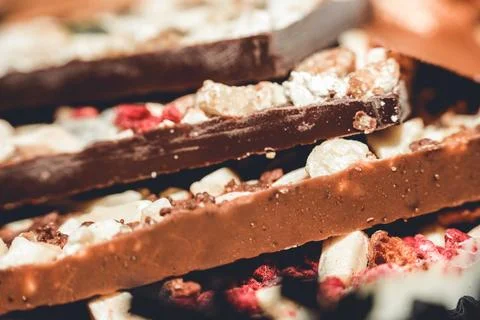 Artisan handmade chocolate bars with nuts and dried fruits close-up Stock Photos