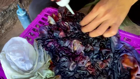 Artisan Hands Applying Liquid Dye Directly on Tied Fabric Stock-Footage 336804913