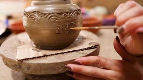 Artisan Hands Carving Intricate Patterns on Clay Pottery Jar Stock Footage 341733129
