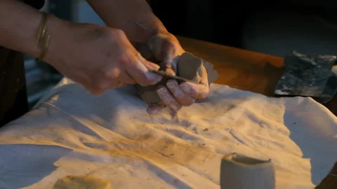 Artisan hands kneading raw clay, preparing the material for sculpting Stock Footage 344003107