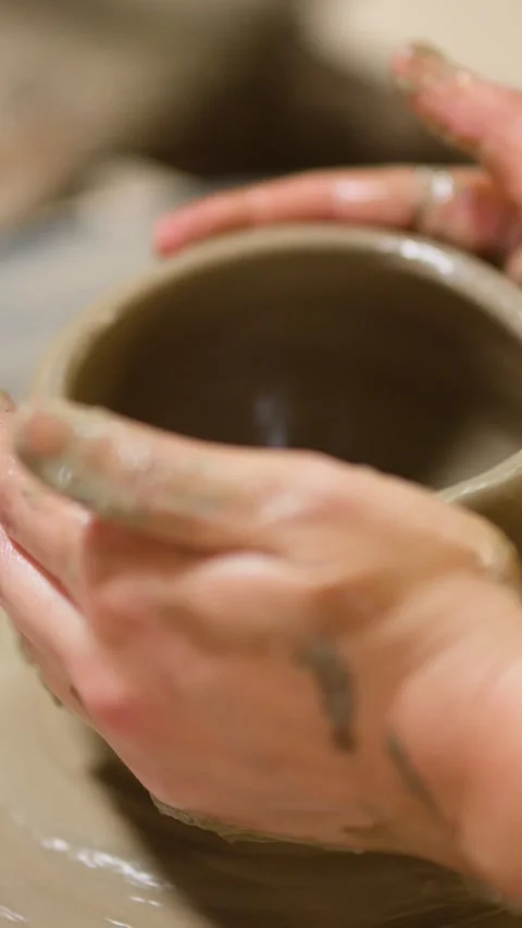 Artisan Hands Shaping Clay Pot on Spinning Pottery Wheel Stock Footage 341373768