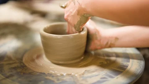 Artisan Hands Shaping Clay Pot on Spinning Pottery Wheel Stock Footage 341536153
