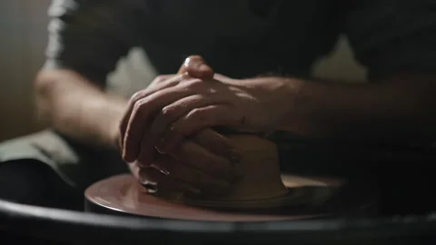 Artisan hands shaping clay on a potter's wheel in slow motion Stock Footage 168536971