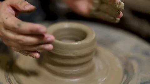 Artisan Hands Shaping Wet Clay on Spinning Pottery Wheel Stock Footage 341069083