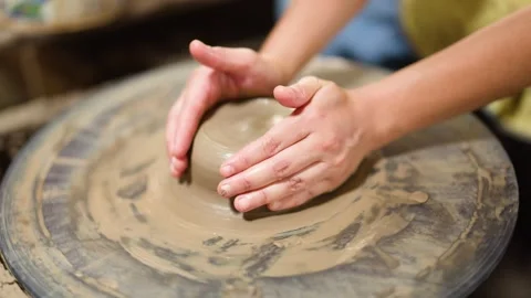Artisan Hands Shaping Wet Clay on a Rotating Pottery Wheel Stock Footage 341302926
