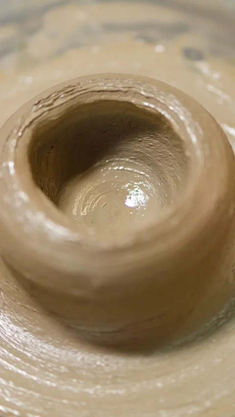 Artisan Hands Shaping Wet Clay Pot on Spinning Pottery Wheel Stock Footage 341373796