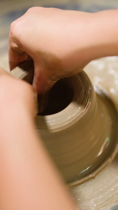 Artisan Hands Shaping Wet Clay on a Pottery Wheel in Thailand Stock Footage 341473213